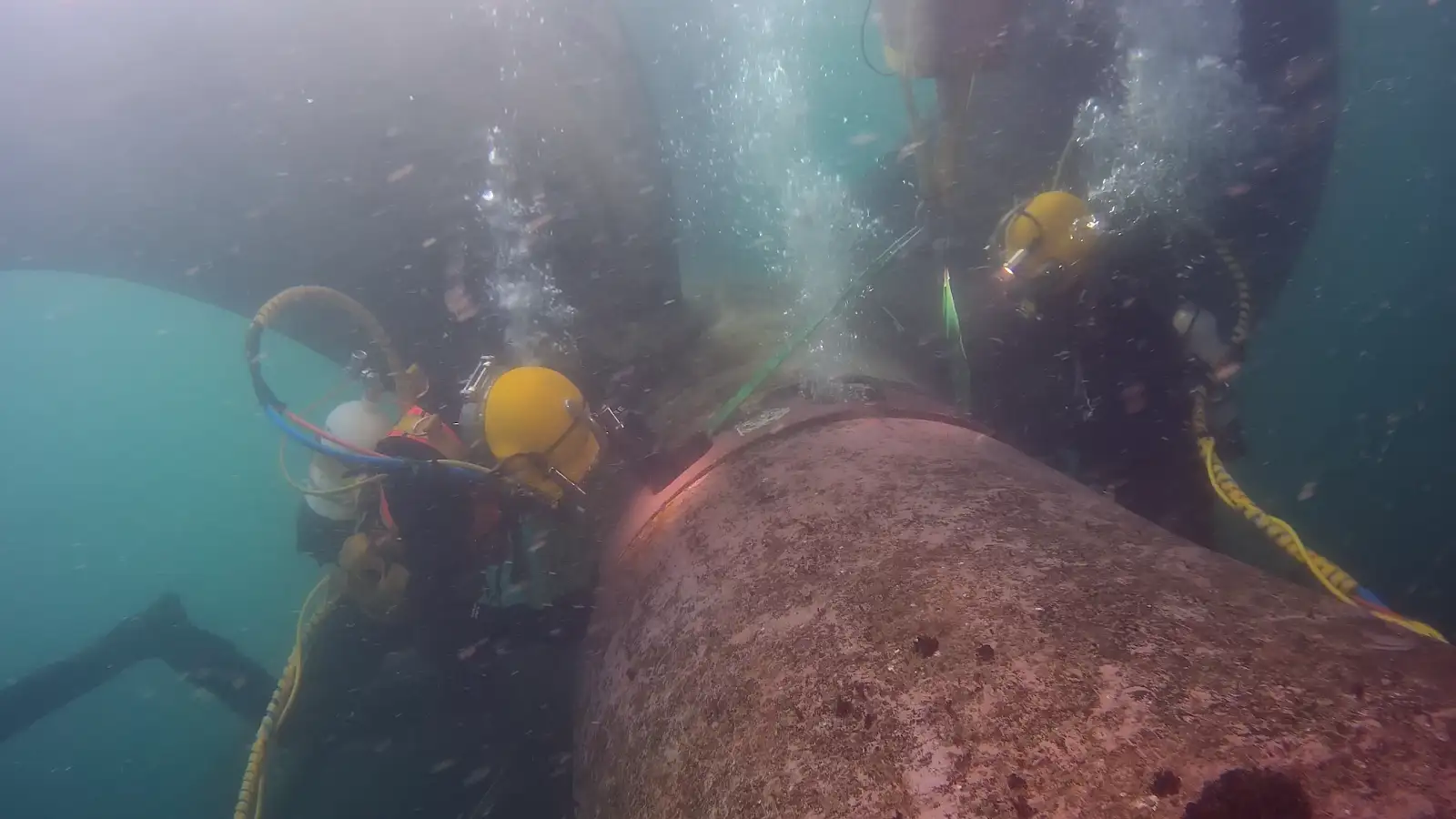two divers performing underwater repair